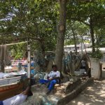 Fishermen resting by their nets