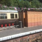 At station with old toilets, milk churns and fire buckets